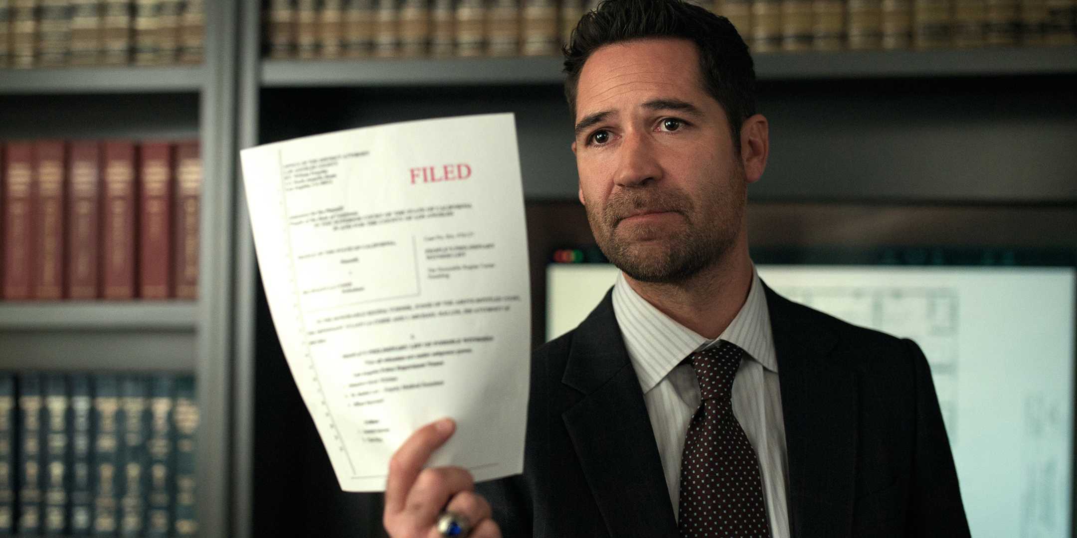 Manuel Garcia Rulfo As Mickey Haller In The Lincoln Lawyer Season 3 Episode 6 Holding Up A Paper Fz